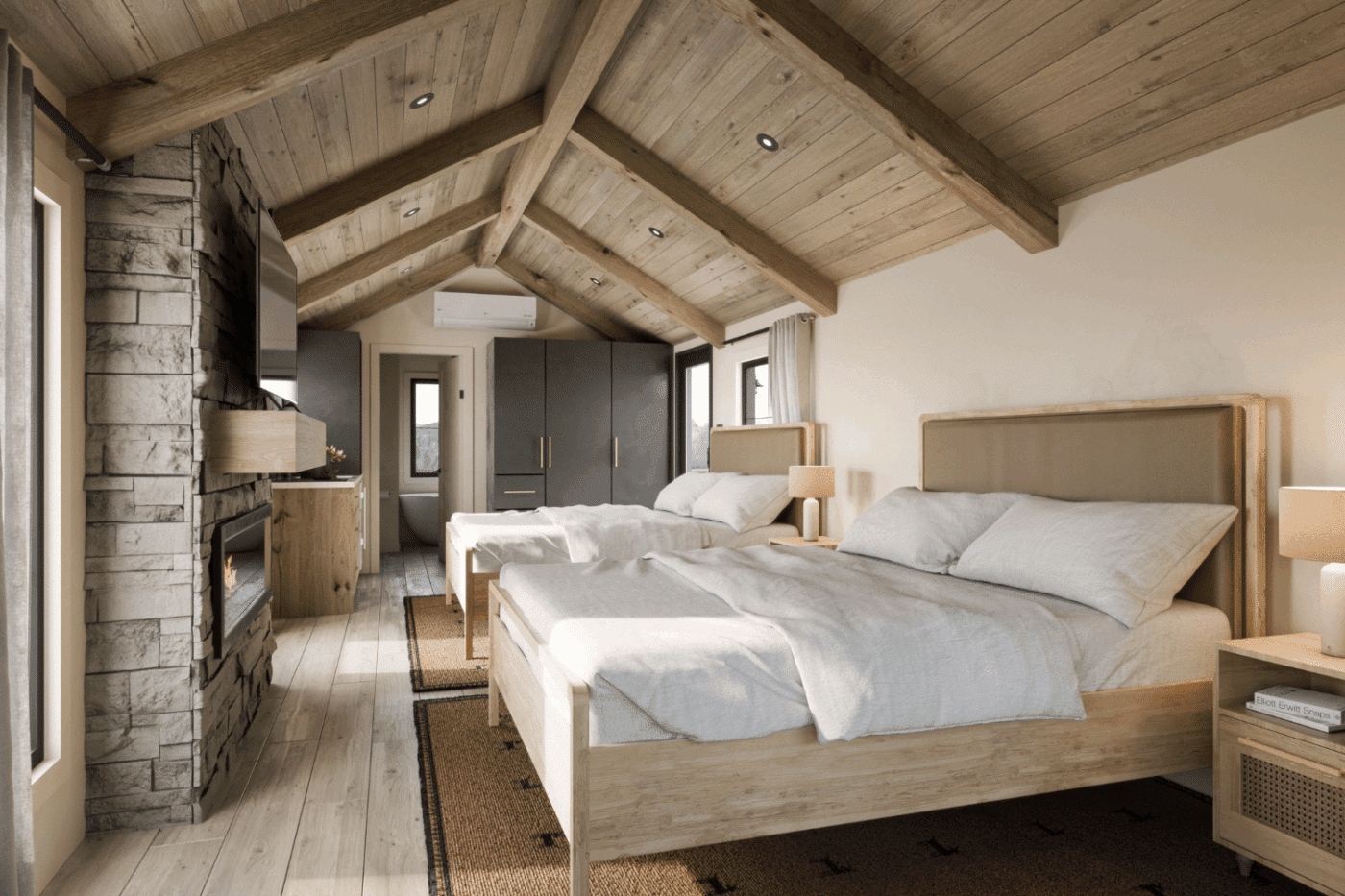 Spacious bedroom interior with vaulted wood ceiling, stone fireplace, and two queen beds.