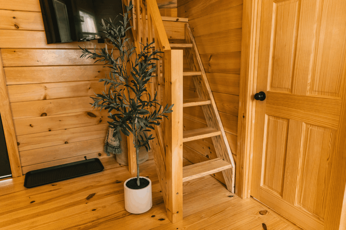 walk up stairs to lofted sleeping area in pinecrest park model tiny home in friedens pa