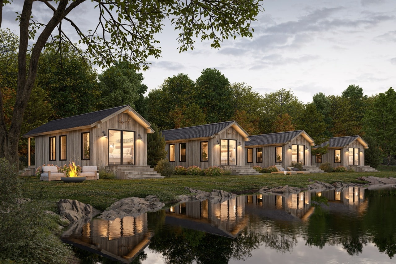 Row of four Yukon park model cabins along a pond, with outdoor seating and fire pit in a wooded Tennessee setting.