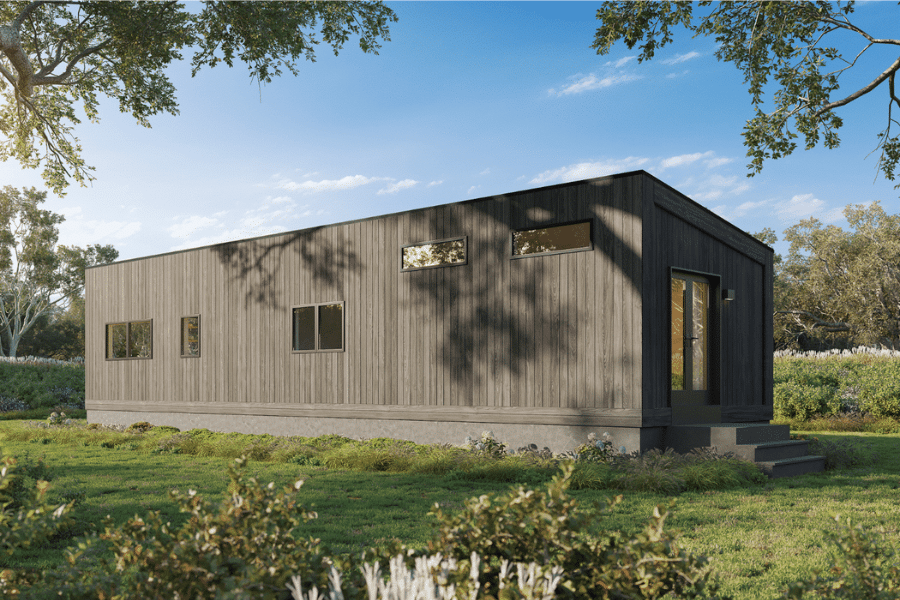 rear side of gray Luna ADU in clearing outside of woods