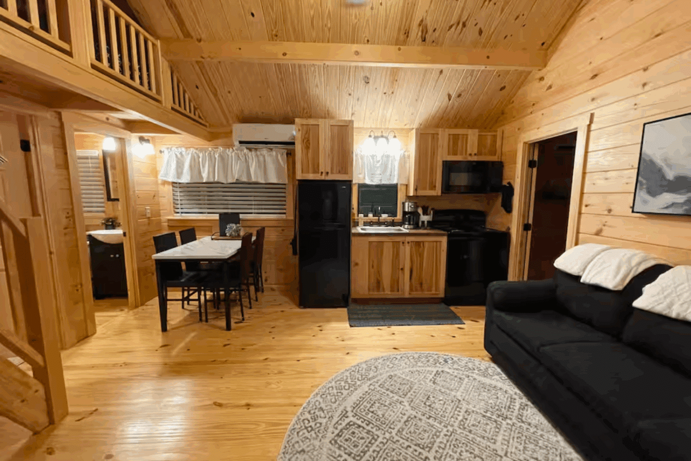 Livingroom dining room and kitchen of Pinecrest park model tiny home located in Fallen timber Pa built and designed by Psy Homes in Gap Pa