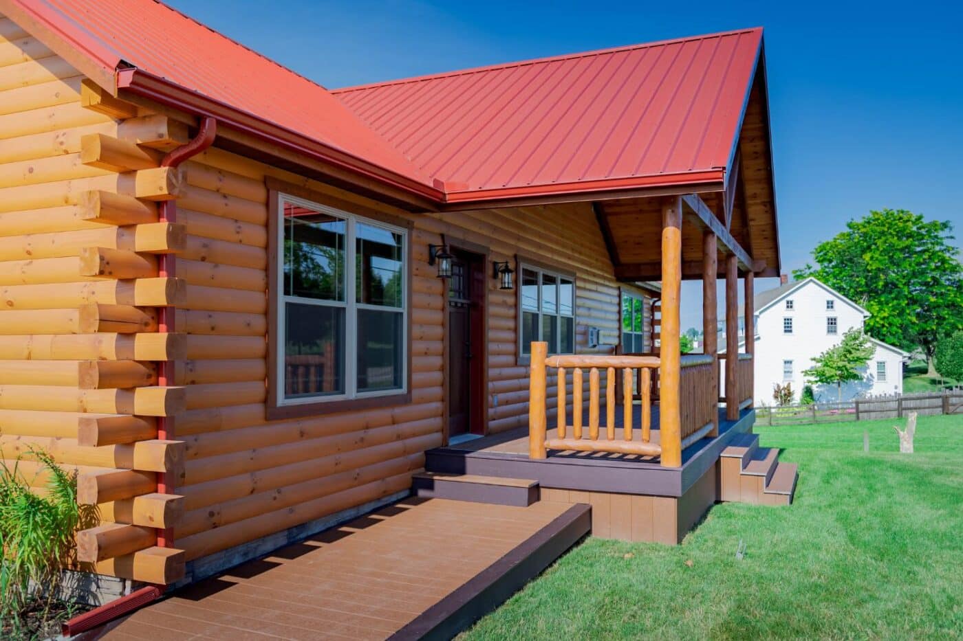 Newly washed log cabin with view of steps to porch and front door