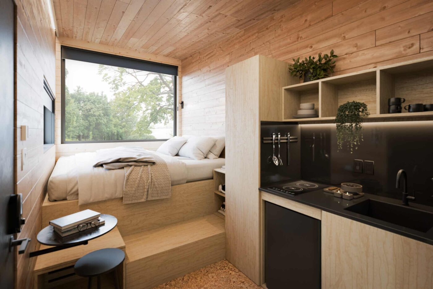 Compact Nook park model studio with bed, kitchen, and wood finishes inside a Rhode Island home.