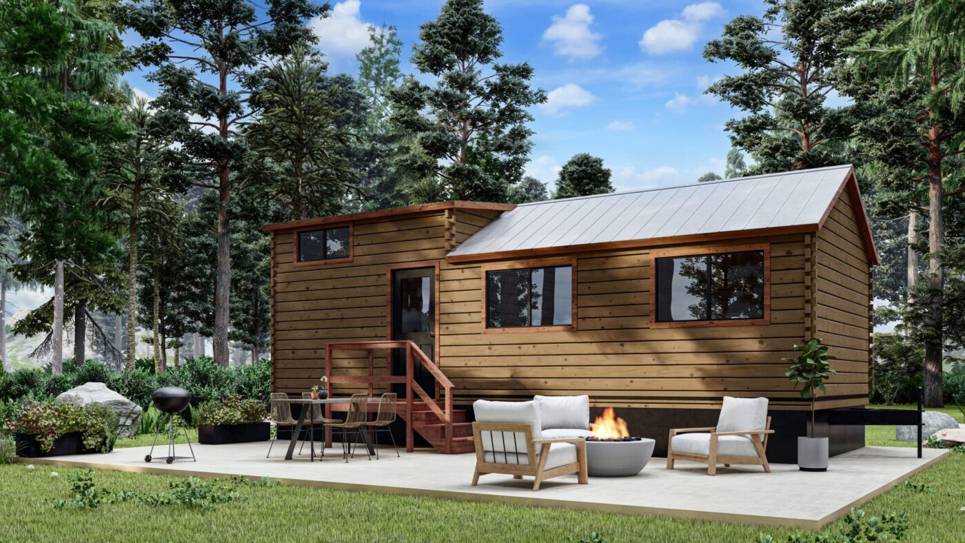 Exterior of a Pinecrest park model tiny home with a wooden deck, seating area, and fire pit.