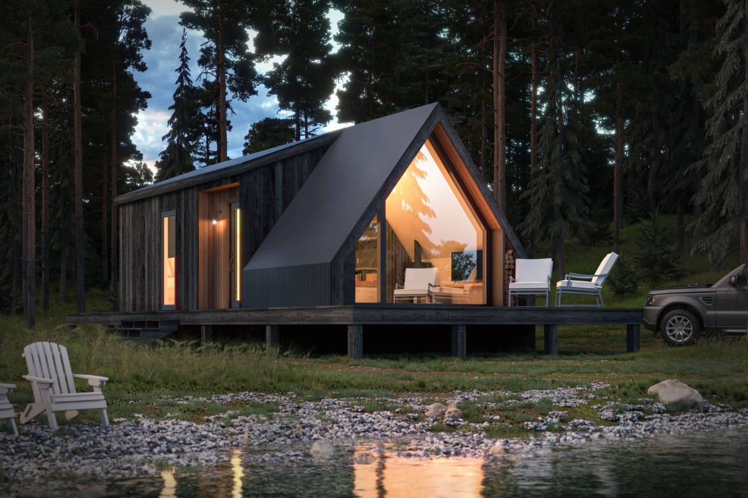 Park Model tiny home, a-frame at night by creek with lights on
