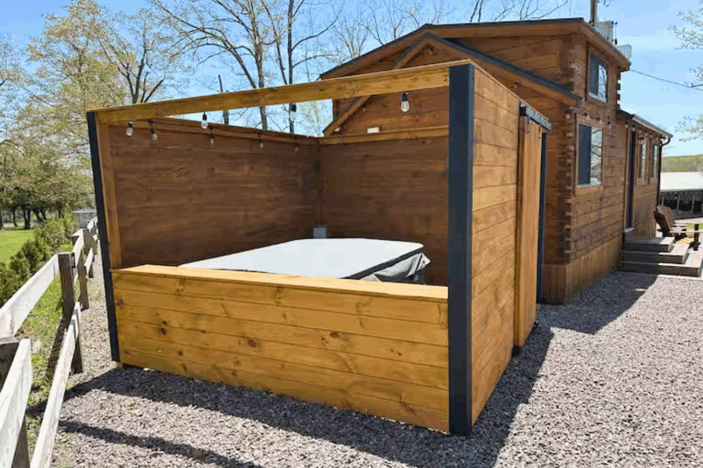 outdoor hospitality area of Pinecrest park model tiny home in friedens pa at Somerset Resort in Friedens pa
