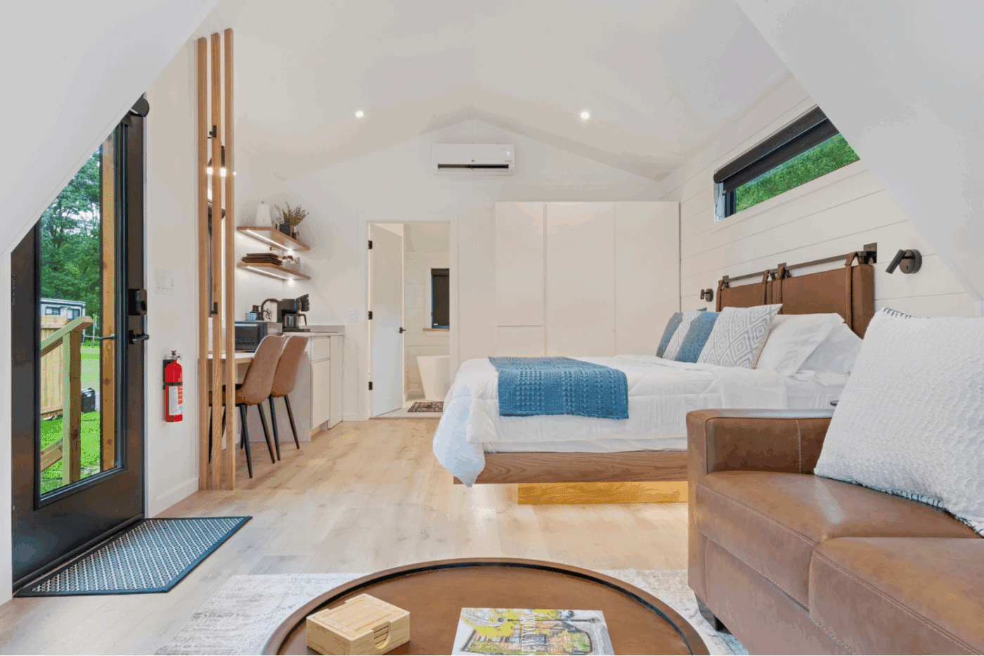 Bedroom and kitchenette area of A frame Studio with large closet Rushing Water 1 in pond eddy New York at The Outpost Resort
