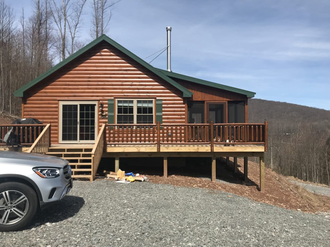 side view of an intricate prefab log cabin in parson west virginia overlooking the moutains