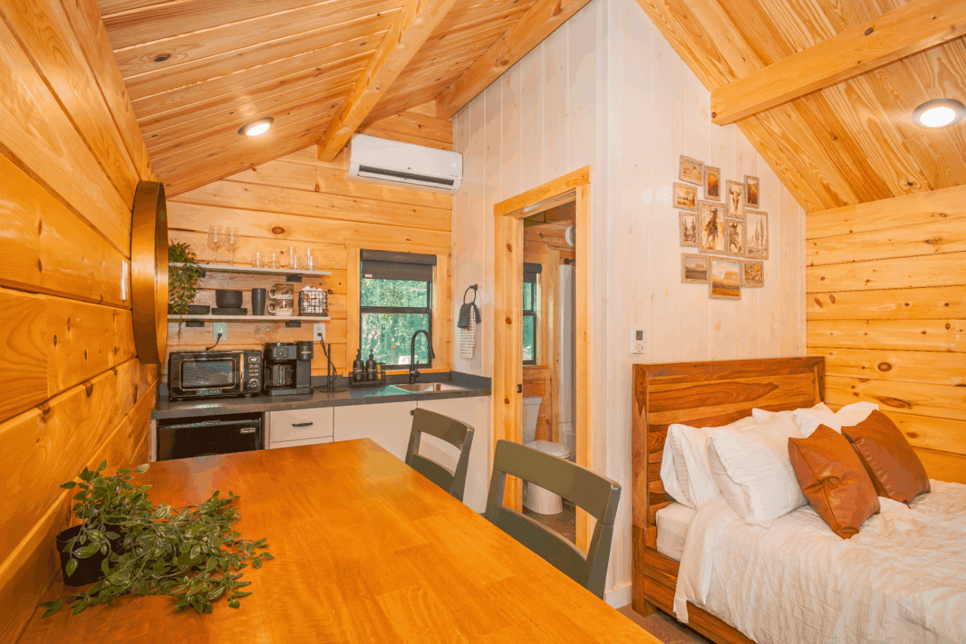 kitchen and dining area of log studio park model tiny home at The Outpost in Pond Edd New york cabin 2