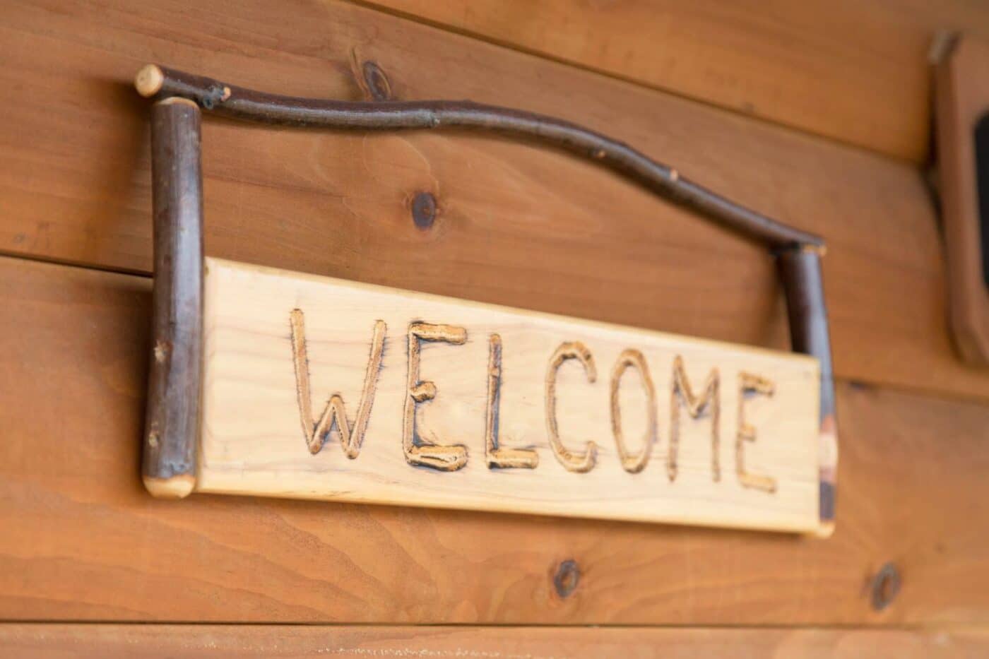 Close up of welcome sign on Zook Log Cabin