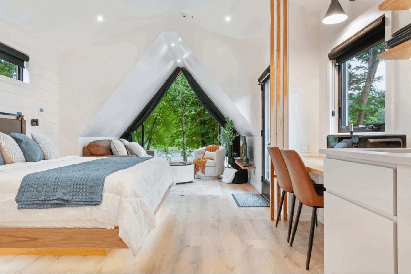 Rushing Water 2 A frame Studio park model with dining area king sized bed and living room in Pond Eddy New York at The Outpost Resort