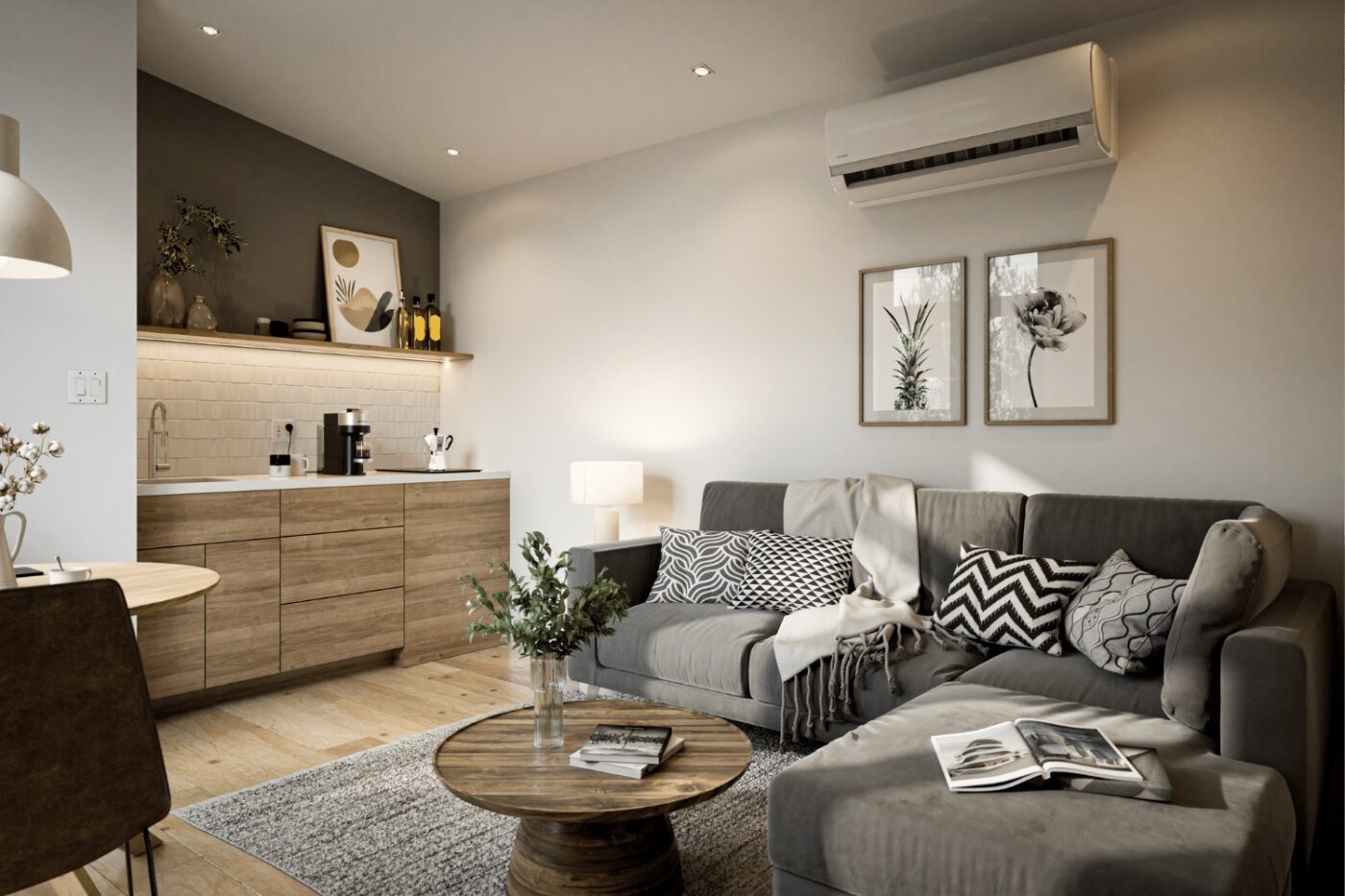 Bright living room of a Sonoma park model with a gray sectional sofa, wood coffee table, and modern kitchenette.