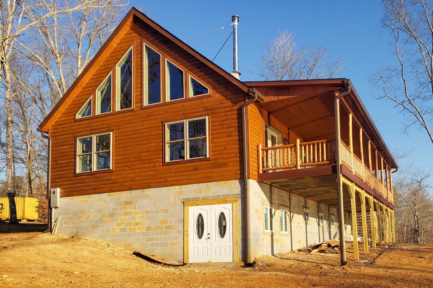 Timberline log cabin with wide porch and stone foundation in North Carolina.