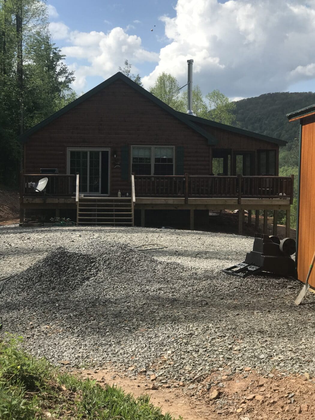 a prefab log cabin in the shadows on a sunny day in parson west virginia
