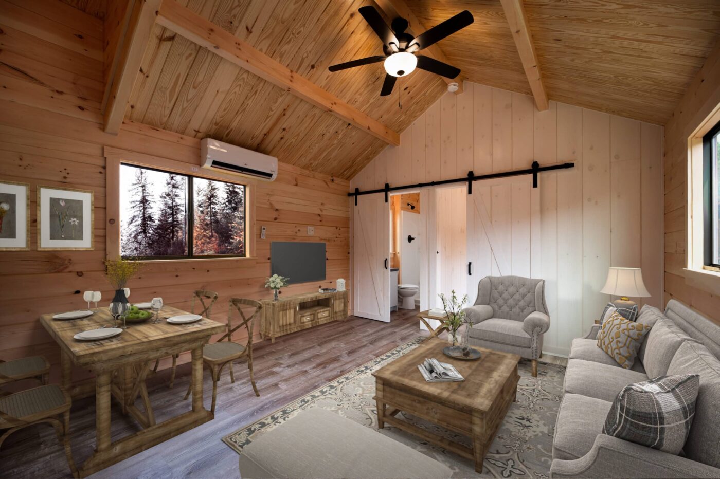 Warm wood-finished living room with vaulted ceiling, barn door, dining table, and cozy seating area.