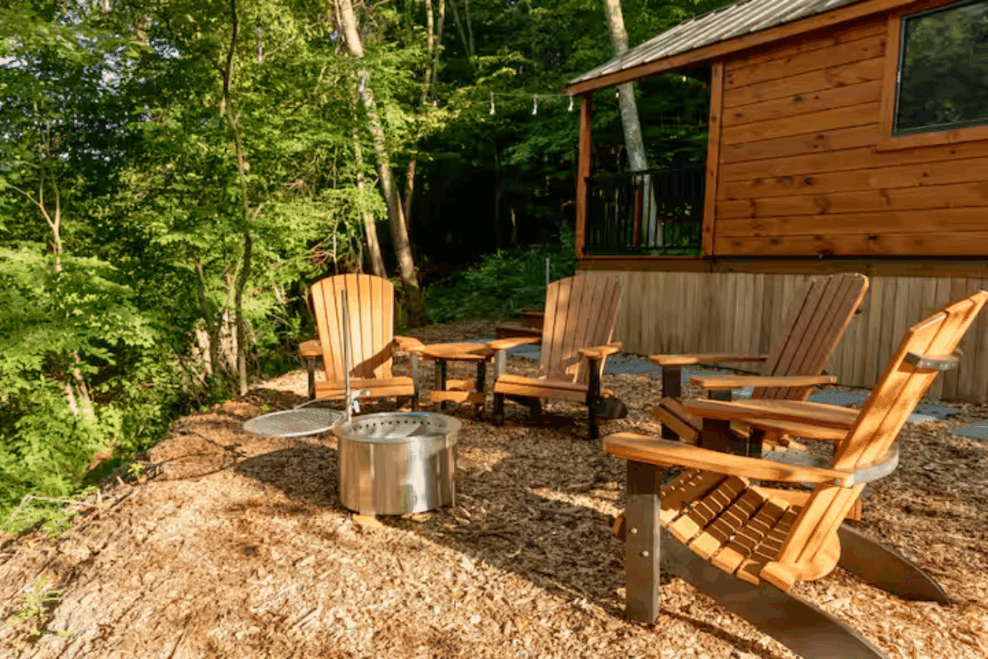 outdoor hospitality area of log studio park model tiny home in James Creek Pa built by zook cabins