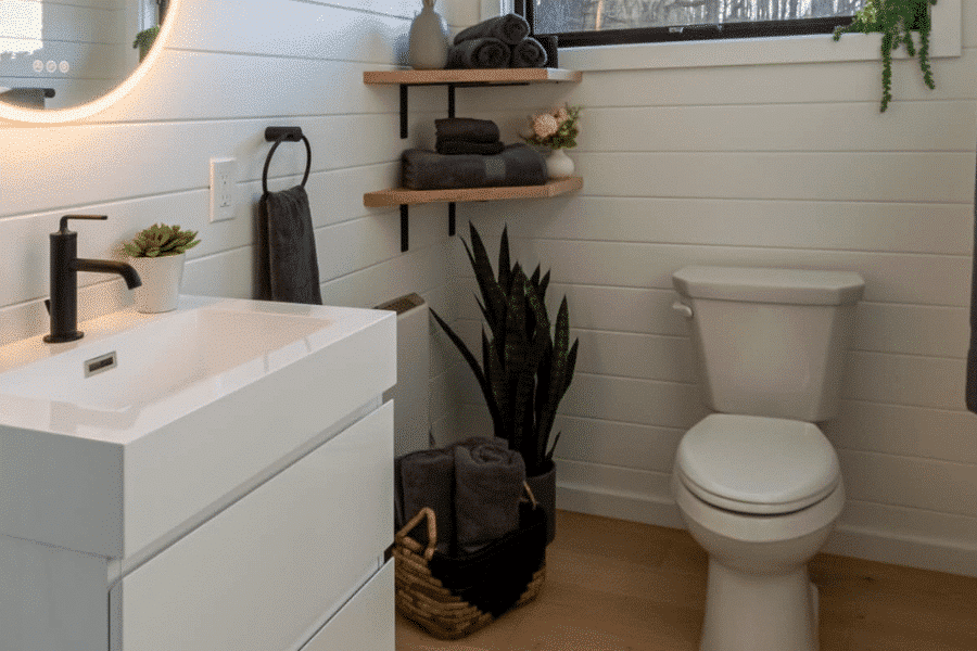 sink toilet shelves with towels inside bathroom in park model tiny homes in VT