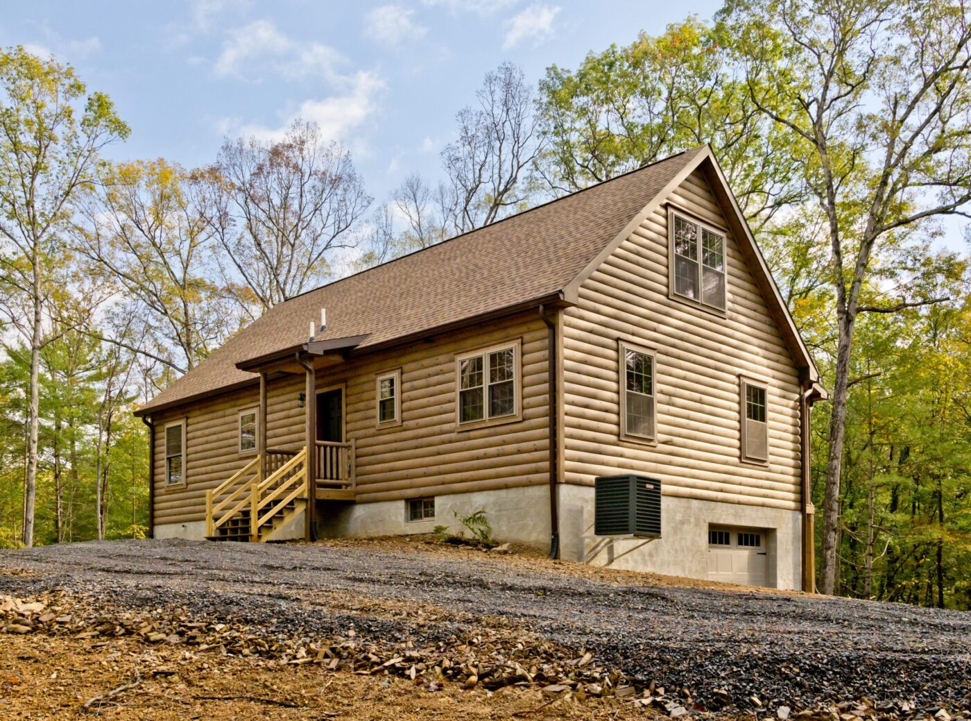 Mountaineer log cabin with stone foundation and wooded hillside, great for Rhode Island settings