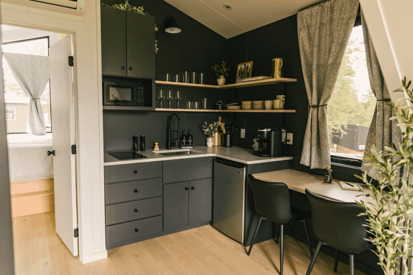 kitchen and dining area of a frame park model tiny home in friedens pa at Somerset Resort at site 11