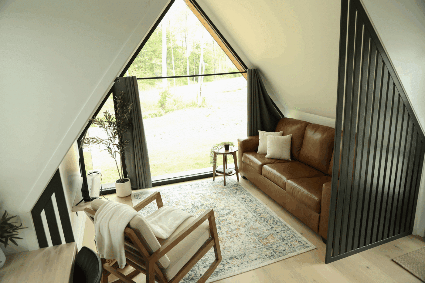 living room of A Frame 29 park model tiny home at HArtment Center in Milroy Pa