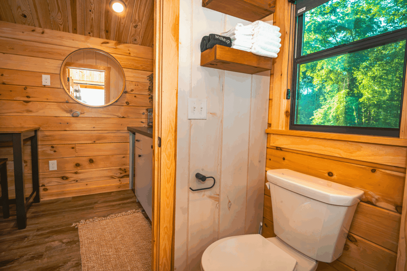 Bathroom of log studio park model tiny home in pond eddy new york at the outpost resort cabin 2